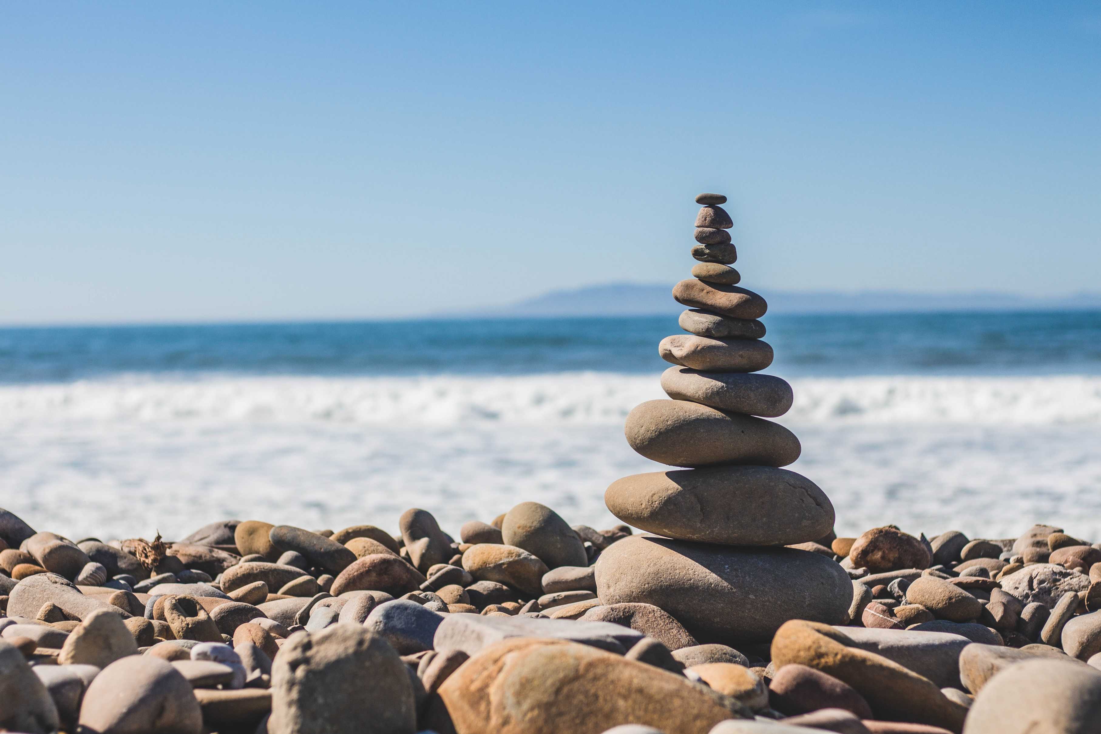 stone balancing with lake background-spirituality